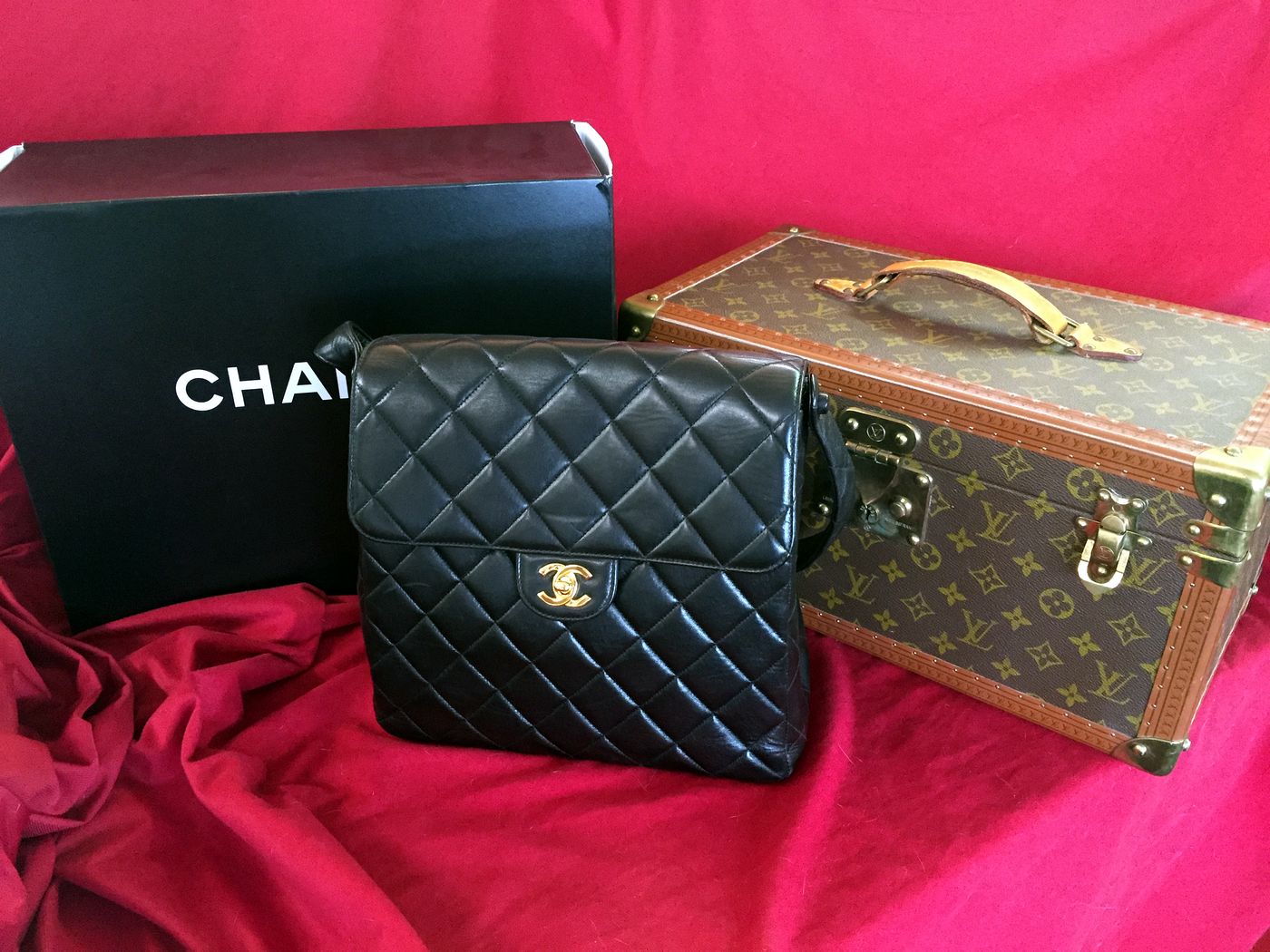 Designer handbag and vintage trunk ready for an opinion of value