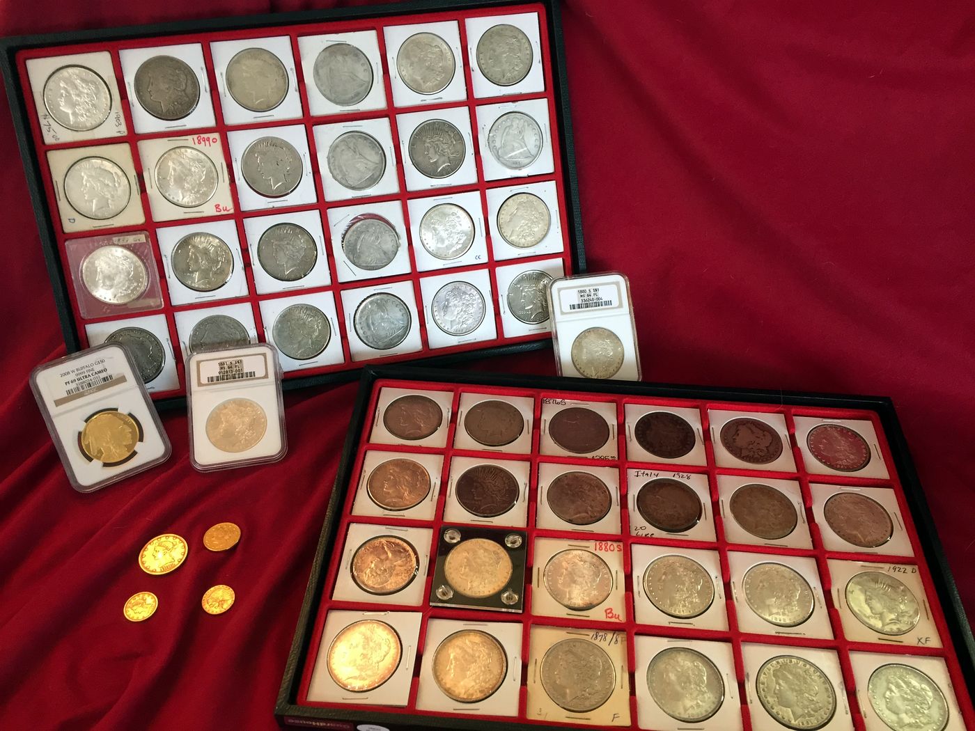 Trays of silver dollars, gold coins and graded coins