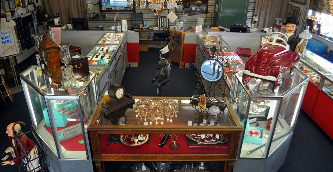 Display cases of estate jewelry, clocks and collectibles inside Sunset Jewelry & Loan